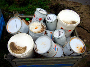 Pesticide containers in trash bin