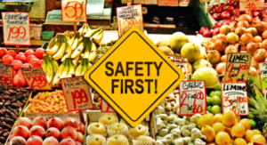 Produce area in market with a safety first sign in front