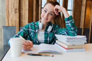 Female student with text books and notebooks