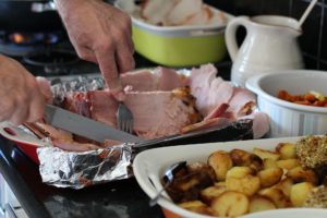 christmas meal featuring ham, potatoes, gravy