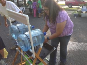 lady washing hands at mobile hand wash station