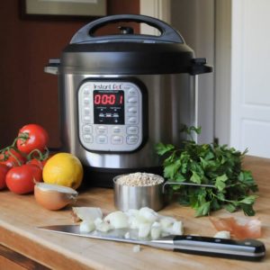 Multi Cooker with vegetables and kitchen utensils
